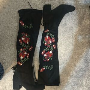 Black suede over the knee heeled  boot with floral accent. NEVER WORN